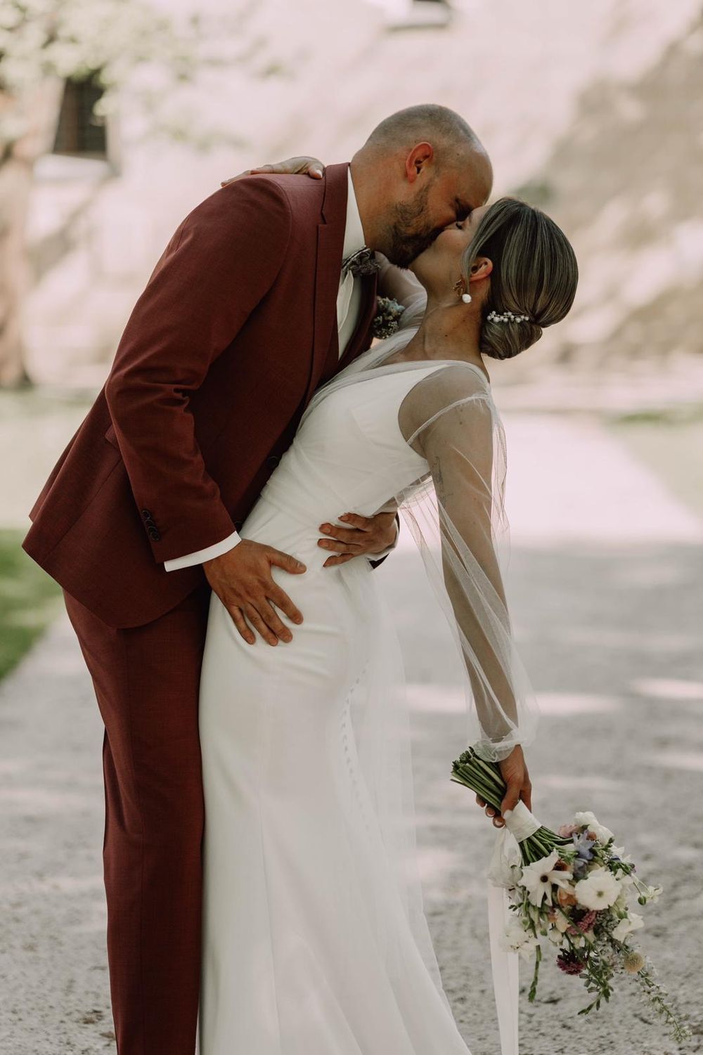 Romantic wedding sequence showing couple in burgundy suit and white dress sharing intimate moment.