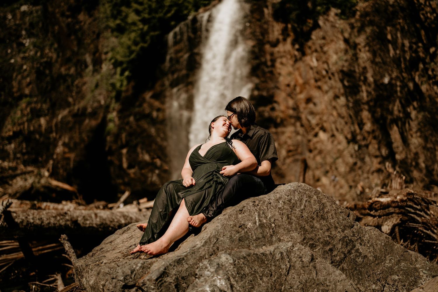 Newly engaged couple posing in front of Franklin Falls Waterfall