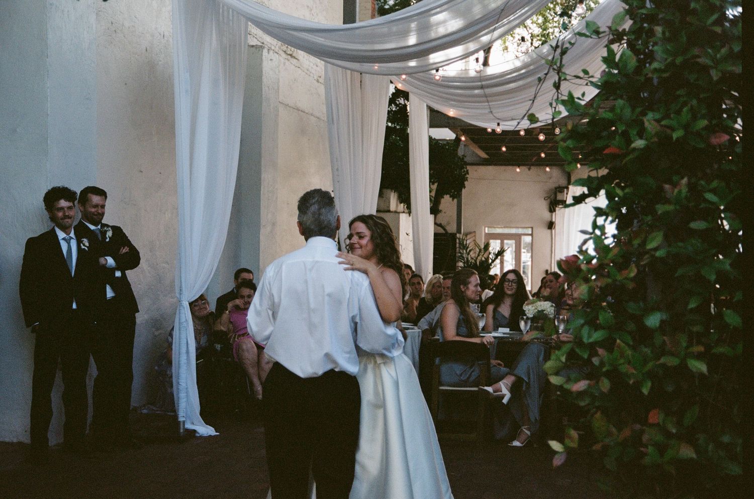 Bride and groom share a romantic moment during their outdoor garden wedding ceremony.