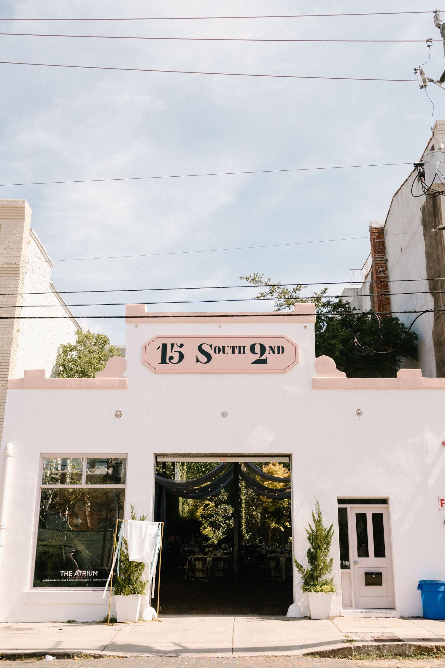 A white modern commercial building with large windows and '15 South' signage on the exterior facade.