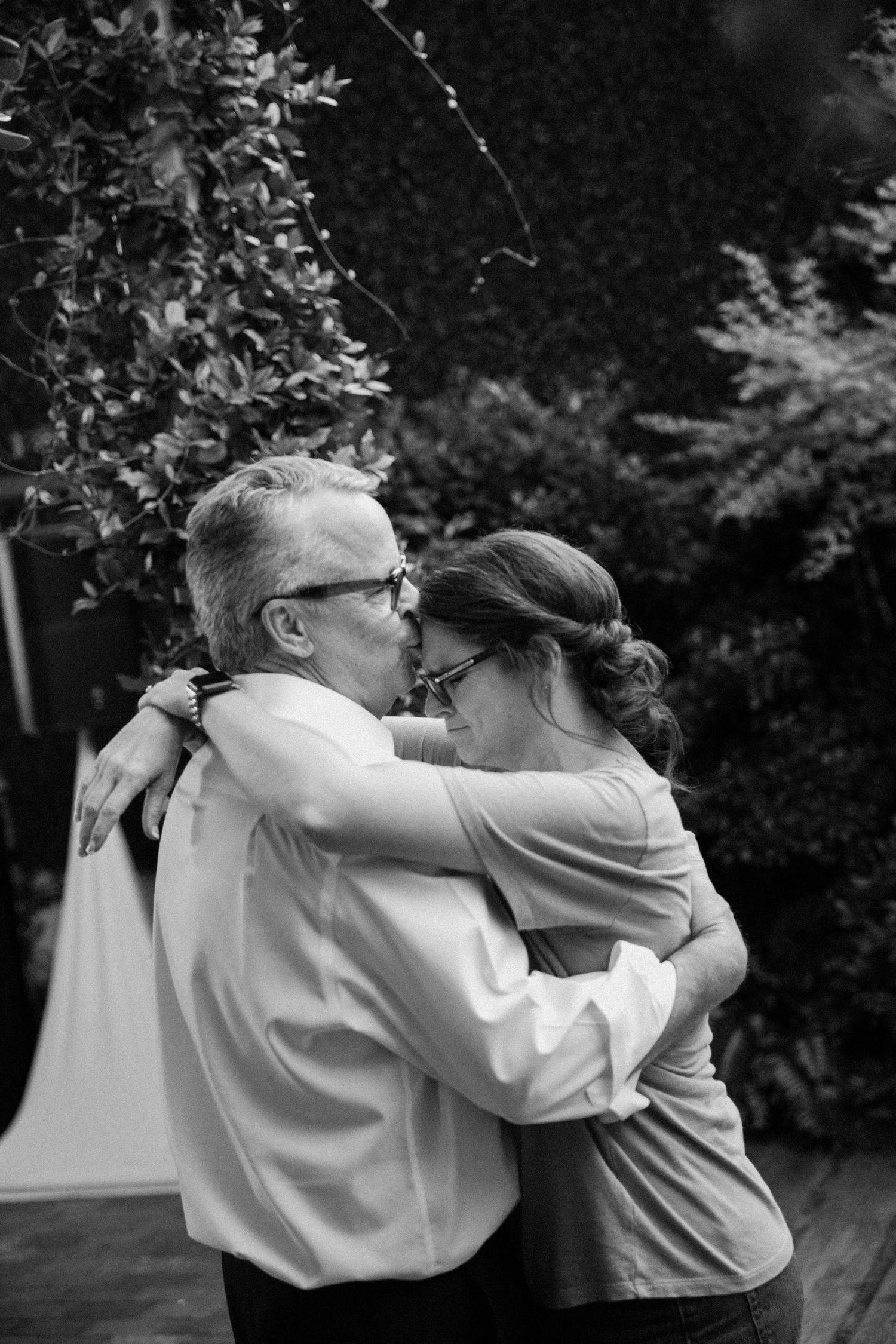 A black and white photo series showing two people dancing together in an outdoor setting.