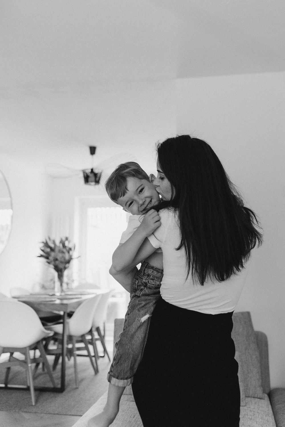 Black and white photos capturing intimate dance-like movements between two people in a home setting.