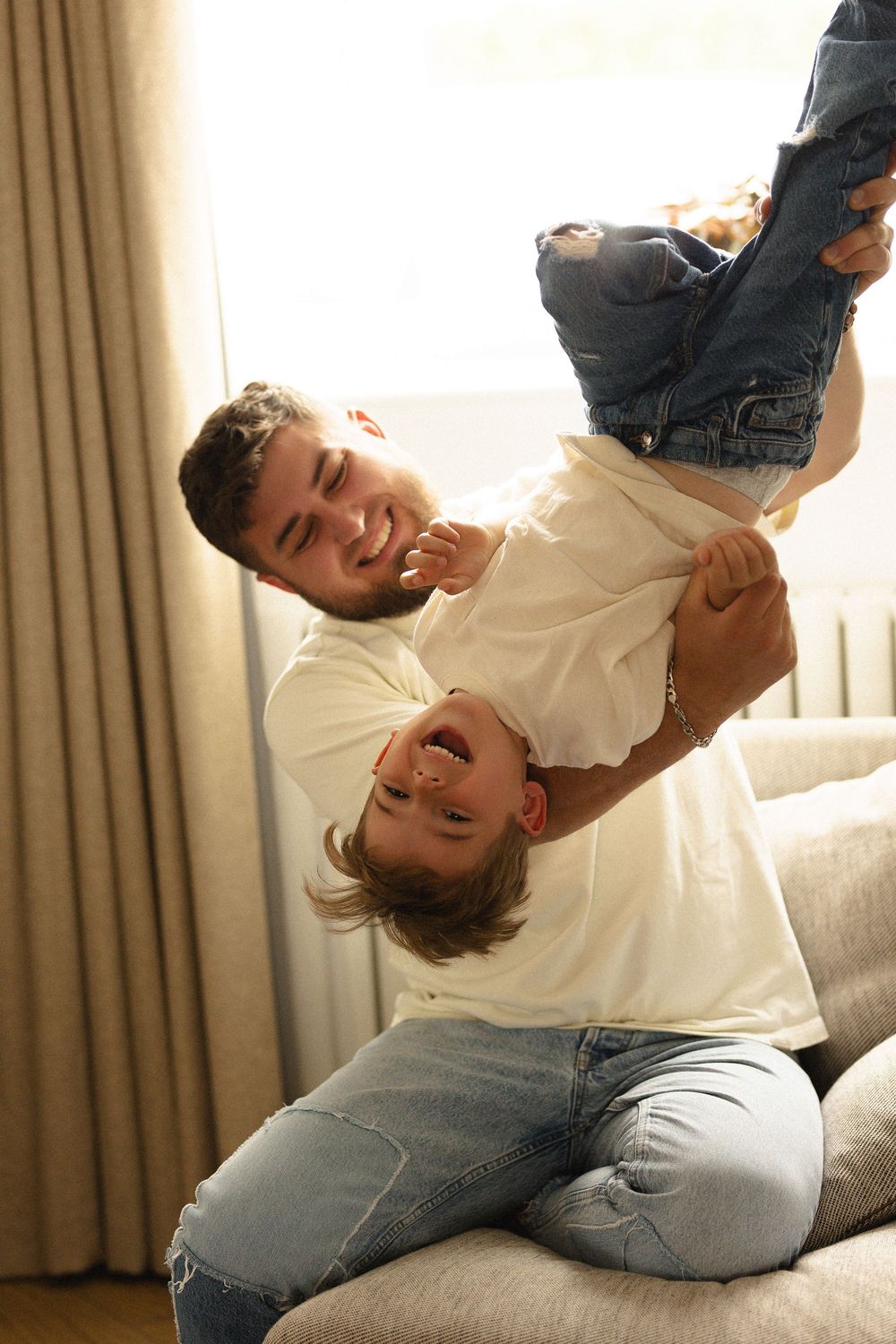 A playful series of photos showing a couple laughing and having fun while lounging on a couch together.