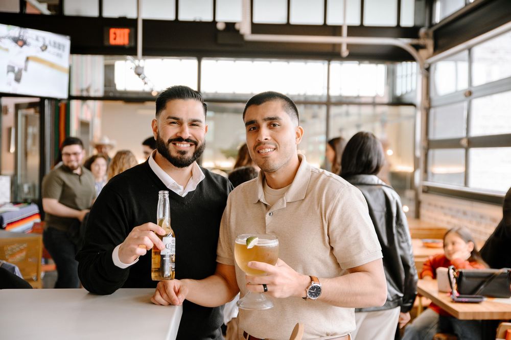 Friends enjoying drinks and casual conversation at a cozy restaurant bar.