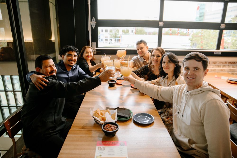Students gather around tables in a cafeteria setting during a social meal or study session.