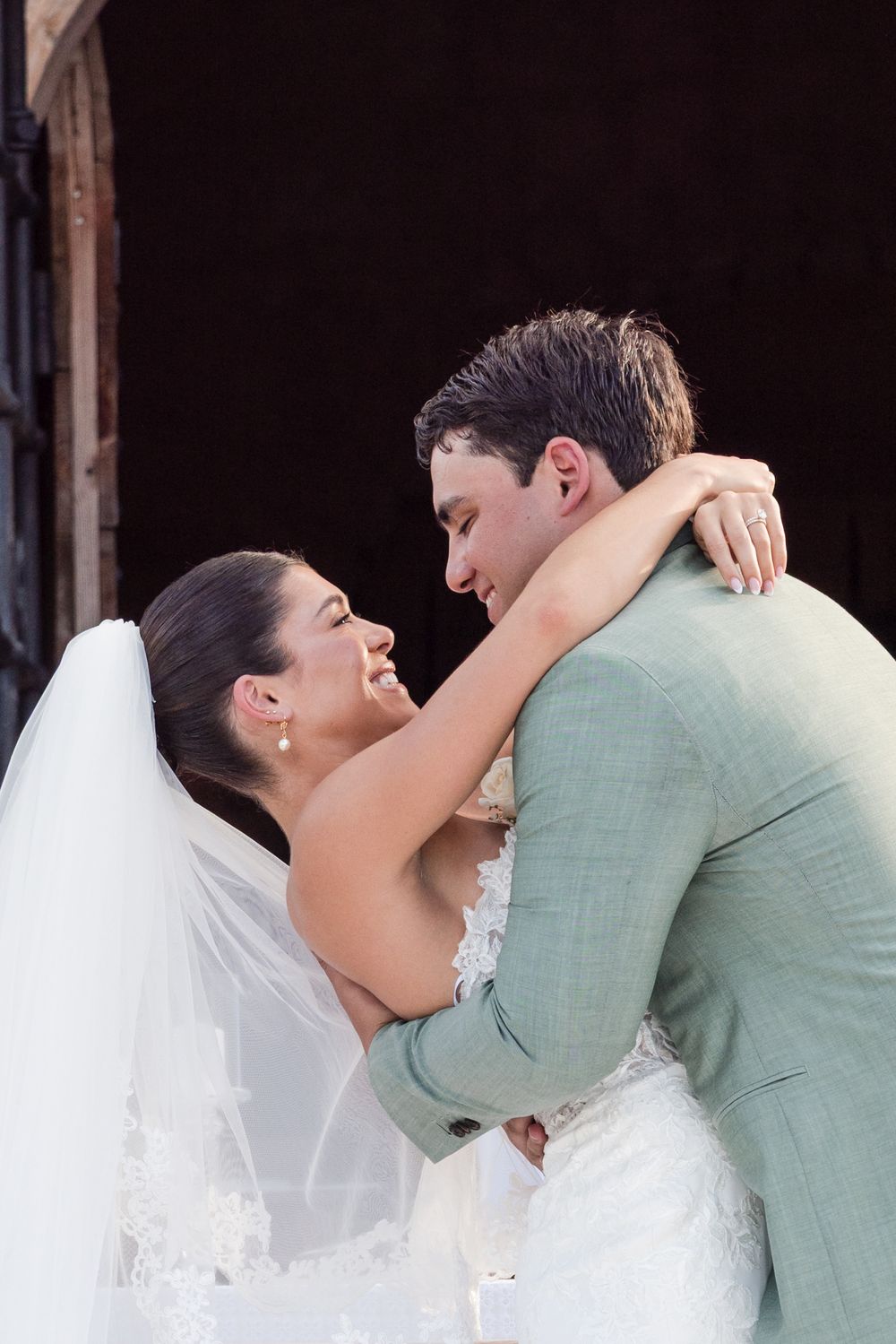 A romantic wedding photo sequence showing a tender kiss between a bride in white veil and groom in mint green attire.