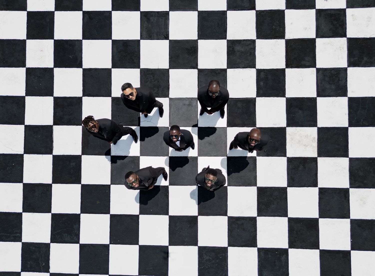 A black and white checkered floor pattern creates a geometric optical illusion with dramatic perspective.