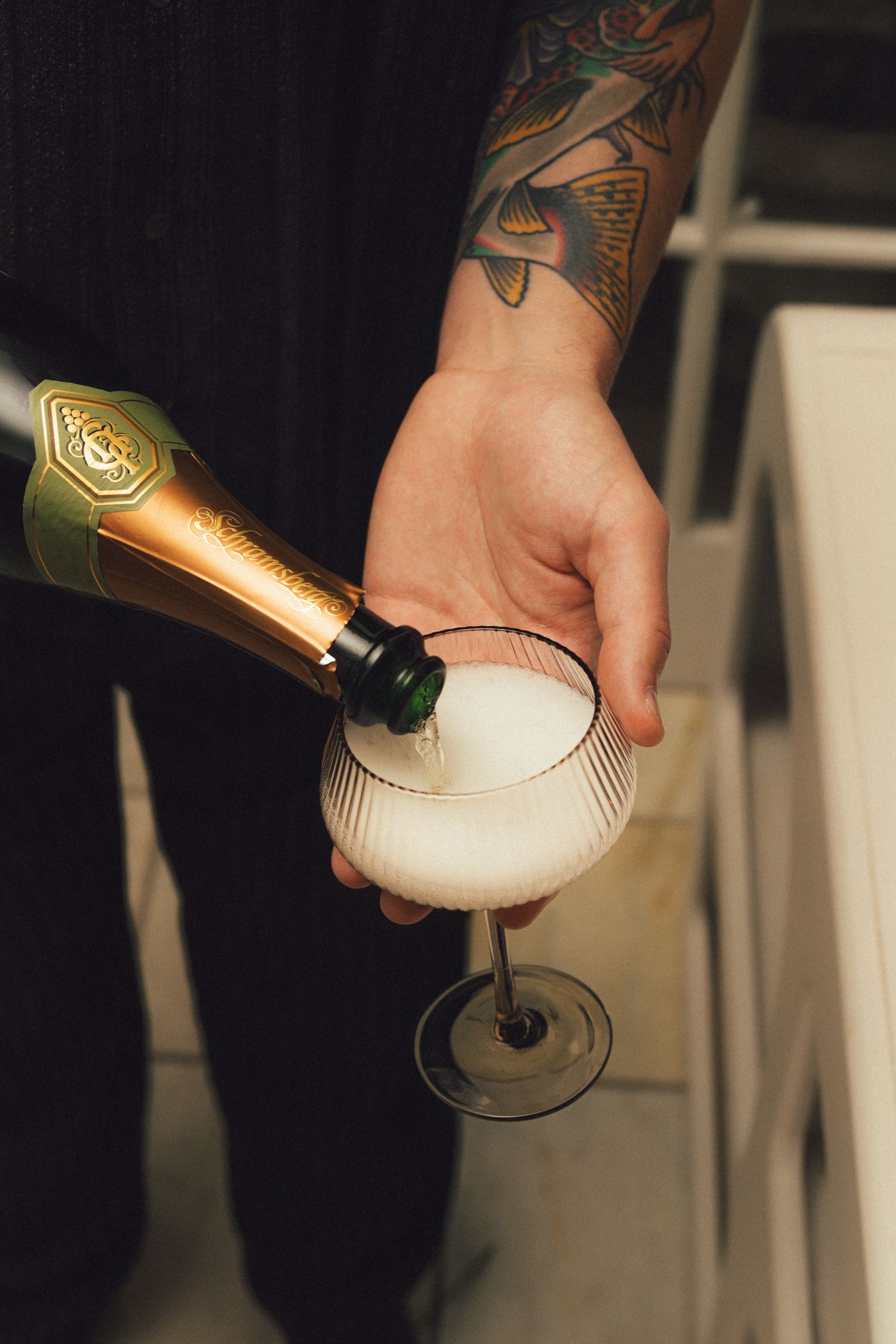 Pouring a glass of champagne with foam rising to the top in a sequence of close-up shots showing the fizzy bubbles.