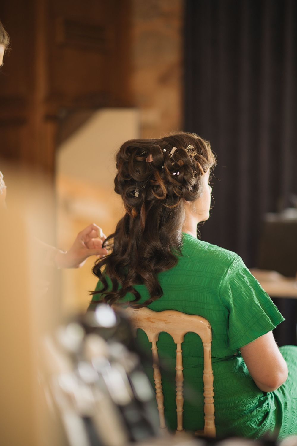Detailed view of intricate wedding hairstyling in progress.