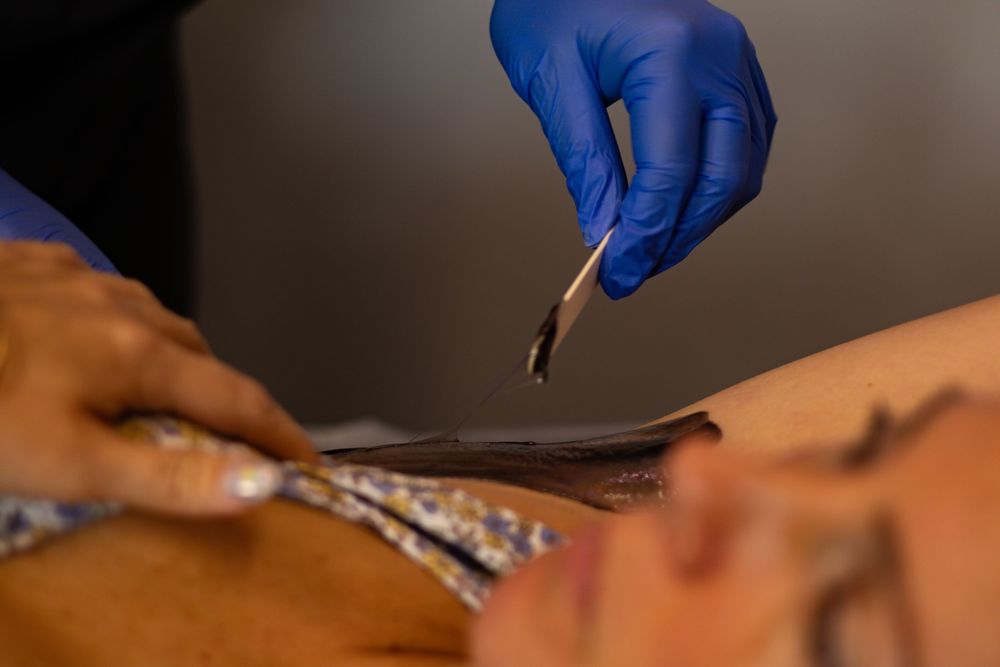 Close-up shot of hands performing precise cosmetic treatment.