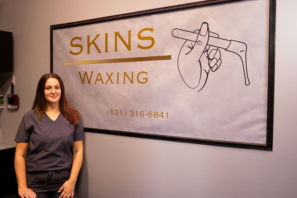 Professional skincare studio interior with waxing services sign and branding on wall.