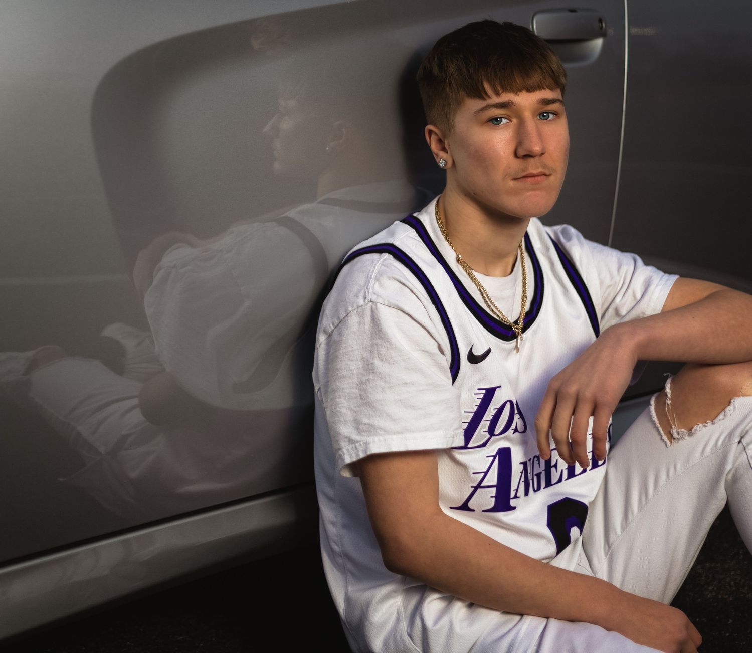 Creative senior portrait in Lincoln, Alabama featuring a modern ghosted reflection effect on a vehicle