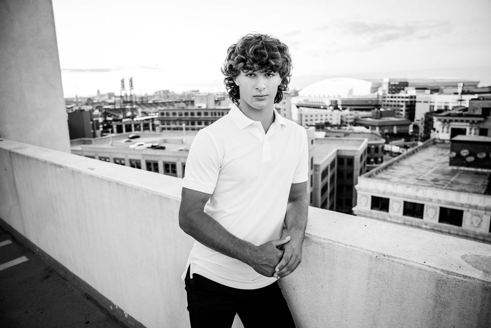 Black and white rooftop portraits with cityscape views in the background.