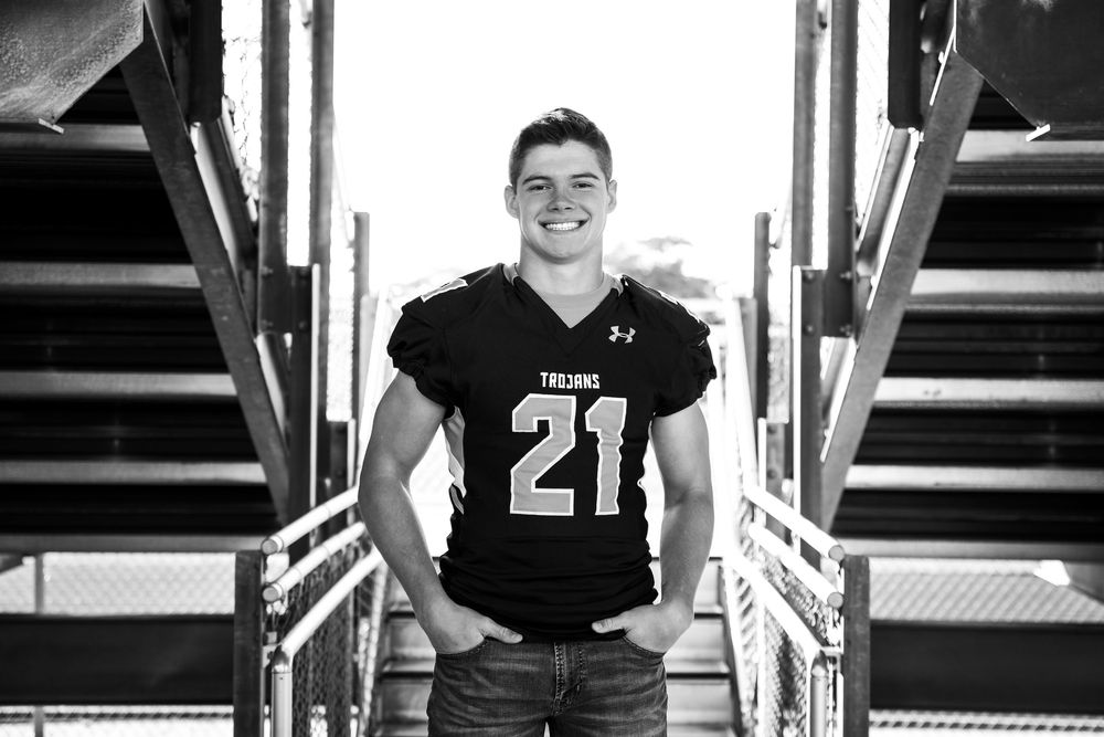 Black and white athletic portraits taken in stadium bleachers.