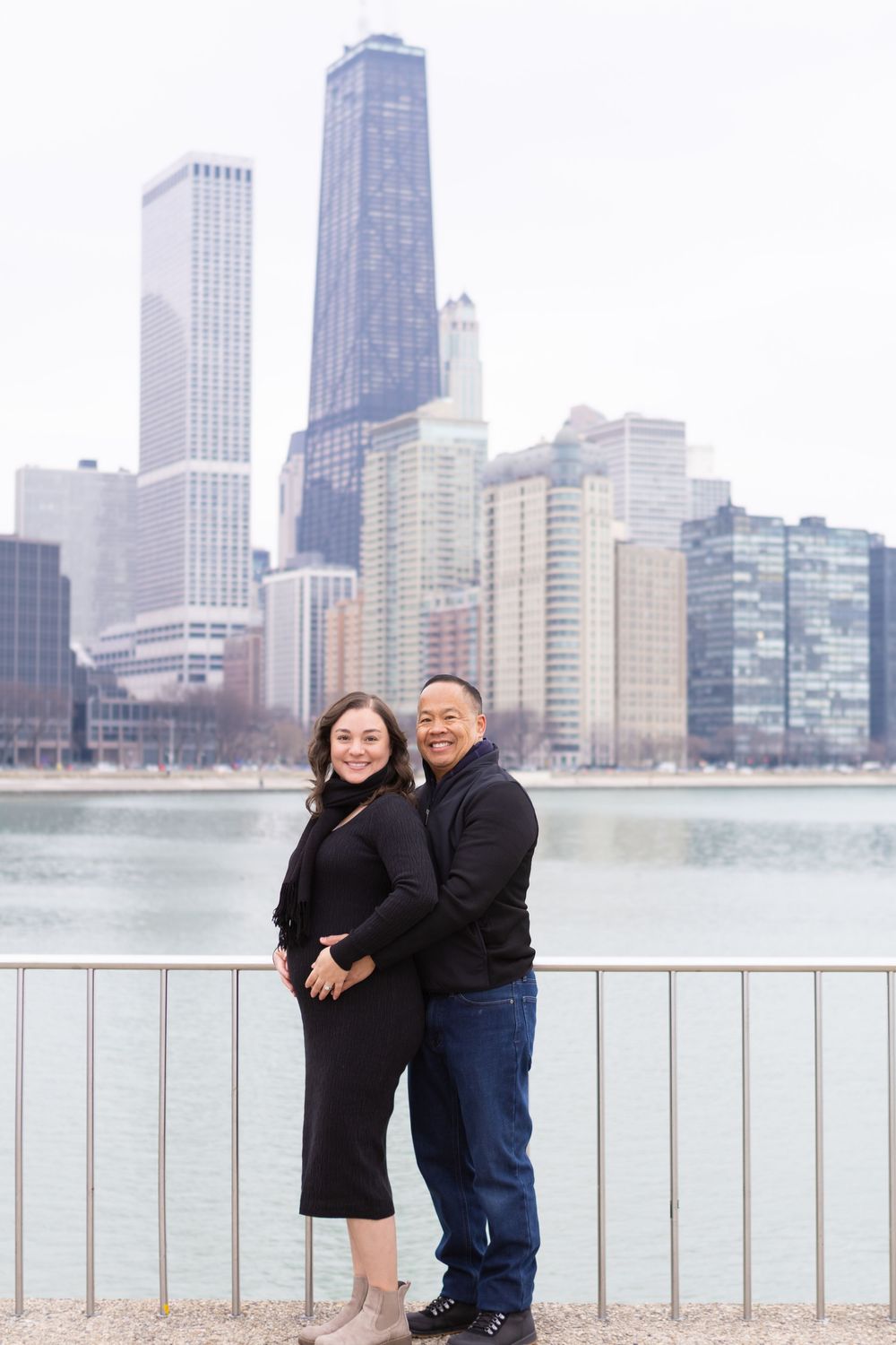 A couple poses along Lake Michigan with Chicago's iconic skyline in the background.