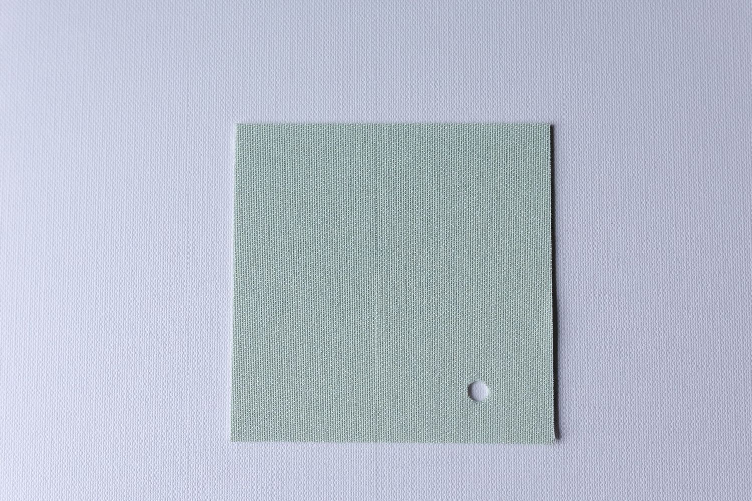 A square piece of olive green fabric or material against a white background.