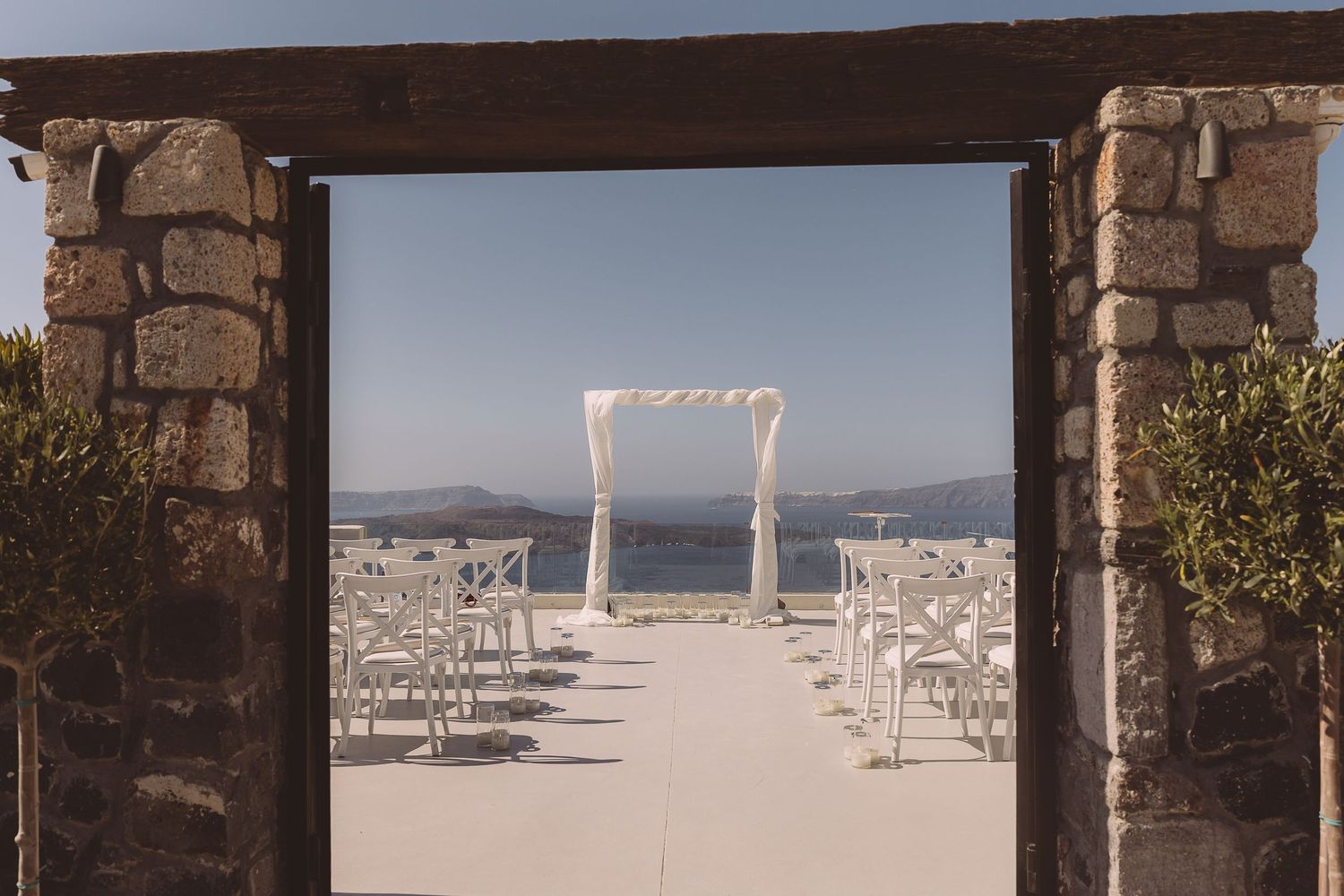 El Viento Santorini wedding setup viewed through stone entrance.