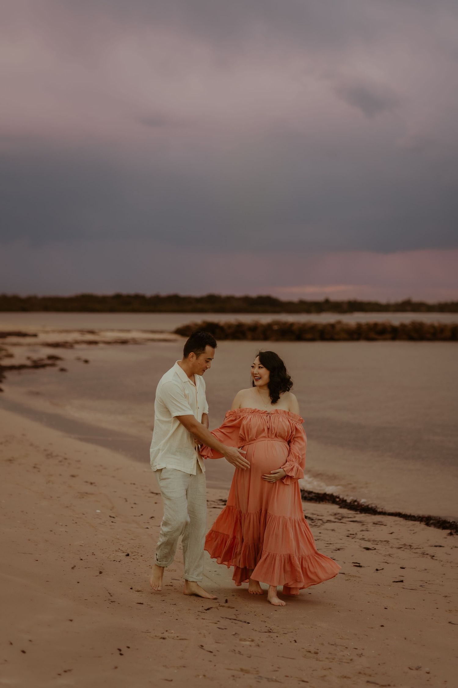 Family Photography during golden hour sunset photoshoot by a serene waterfront with trees in the background at Bonna Point Reserve Kurnell