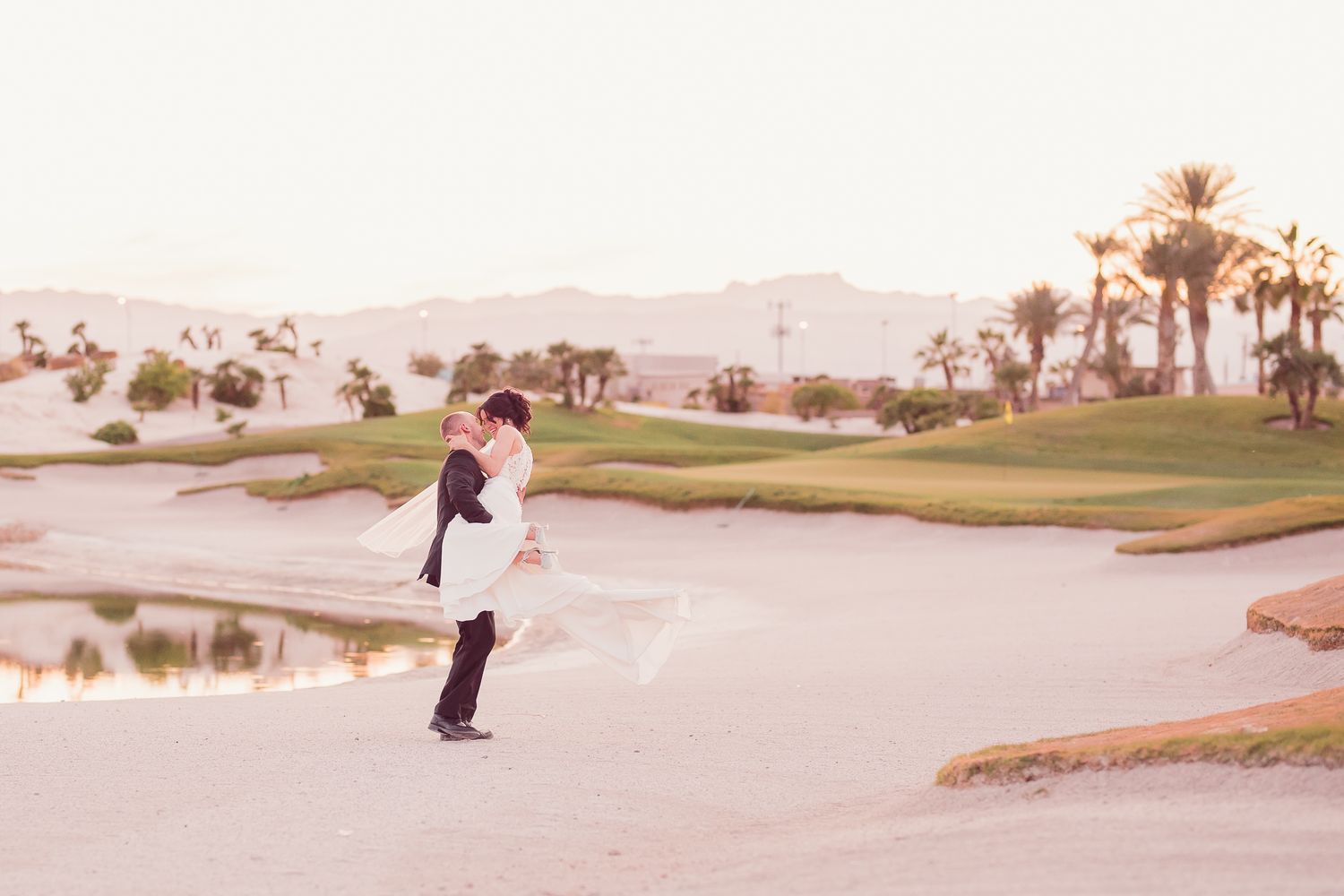 Black and white wedding photos showing a bride in a flowing white dress with a long veil in an elegant hallway setting.