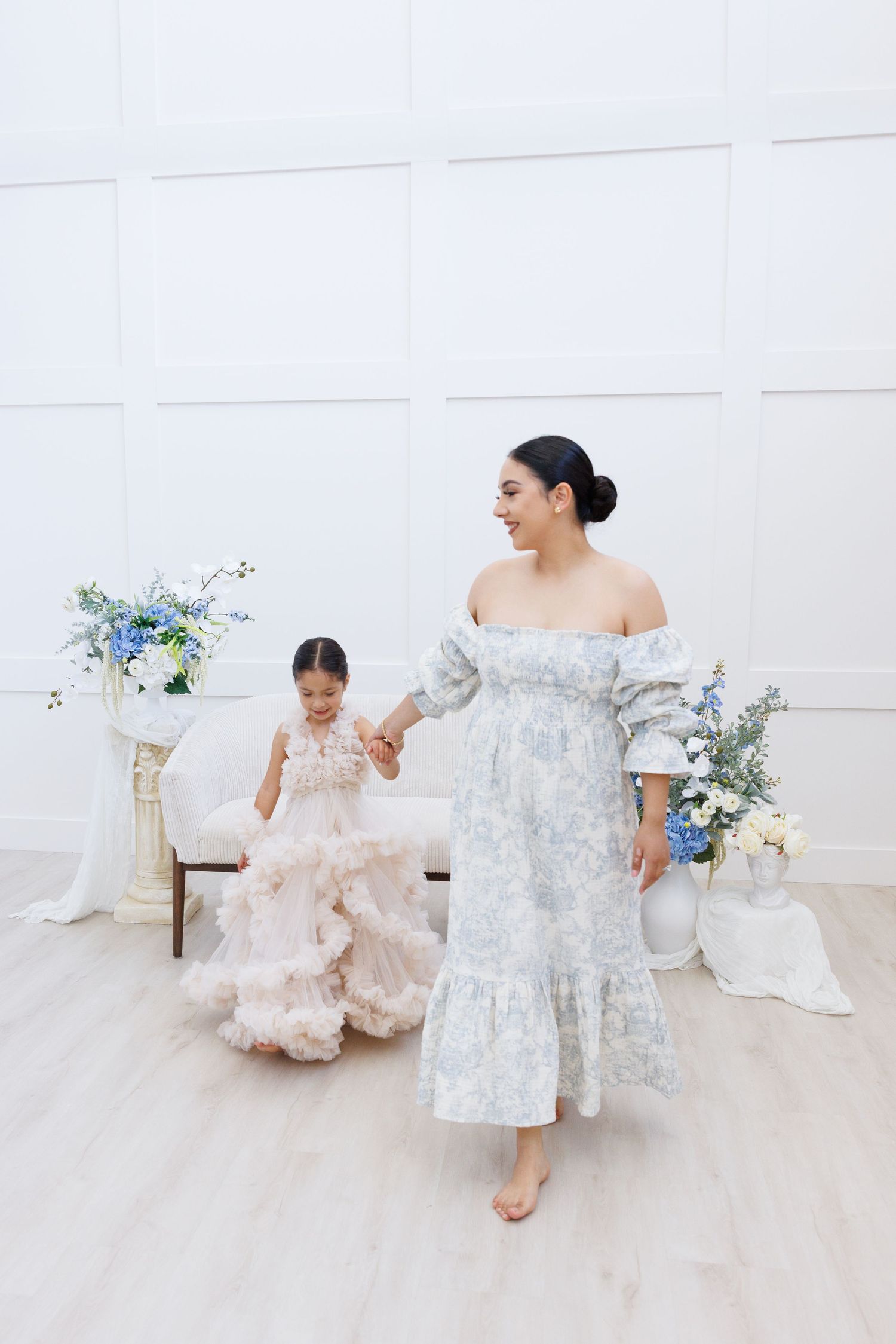 Ethereal bridal boudoir photo series in soft blue and white tones featuring flowing fabric and delicate floral arrangements.