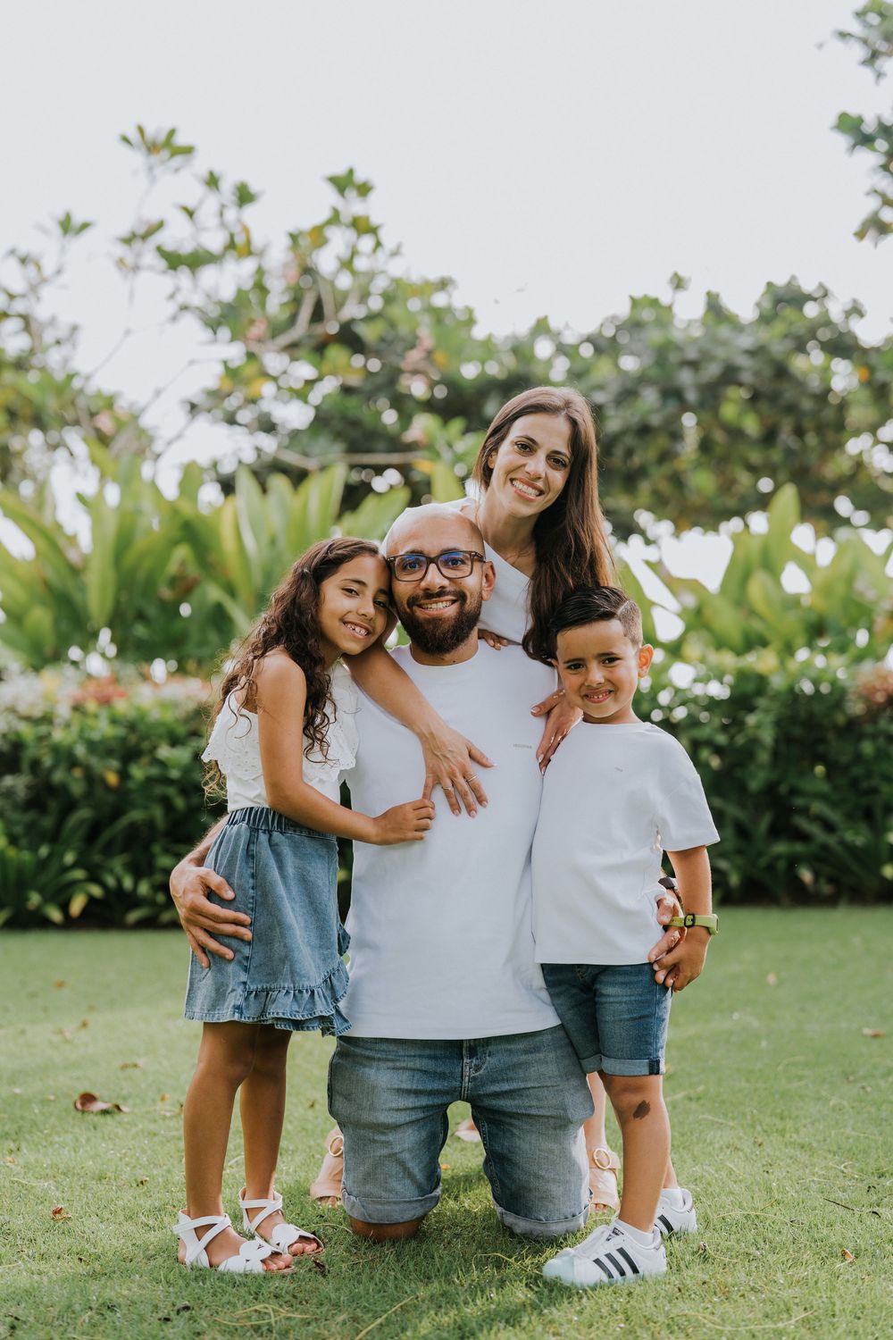 Professional family photoshoot service with beach and ocean background.