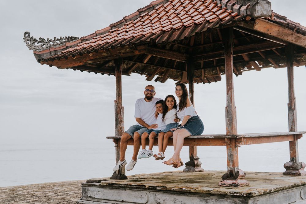 Professional family photoshoot service with beach and ocean background.