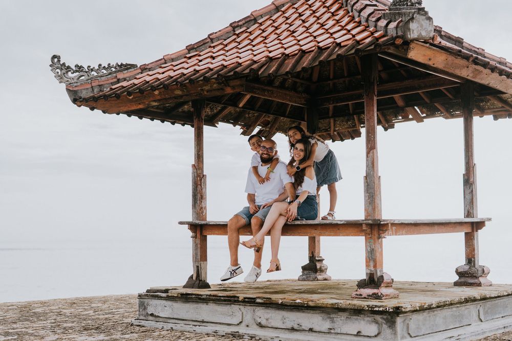 Professional family photoshoot service with beach and ocean background.