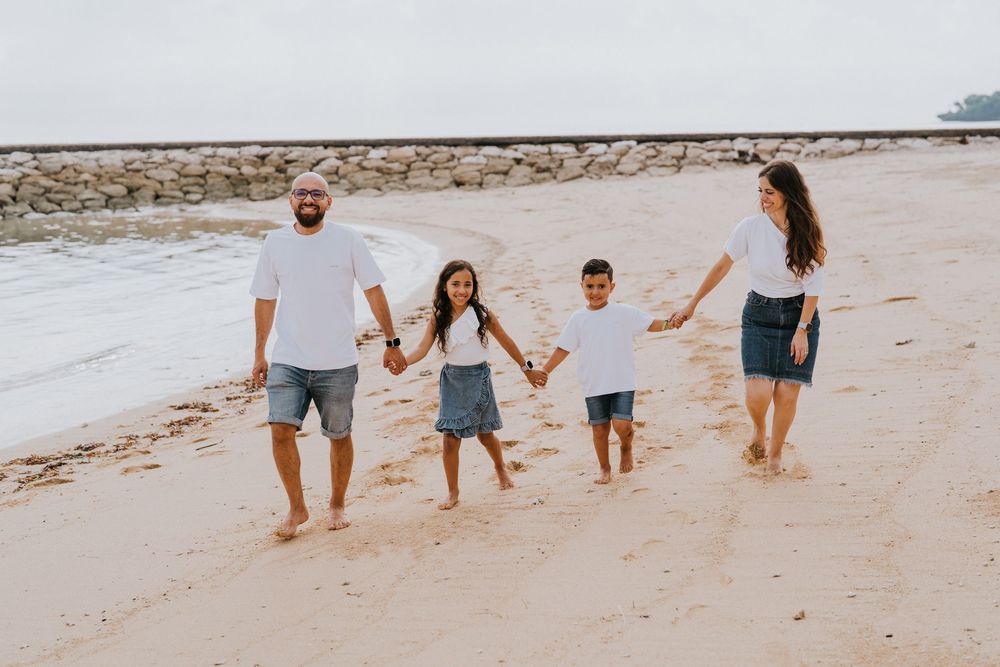 Professional family photoshoot service with beach and ocean background.