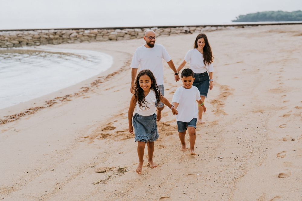 Professional family photoshoot service with beach and ocean background.