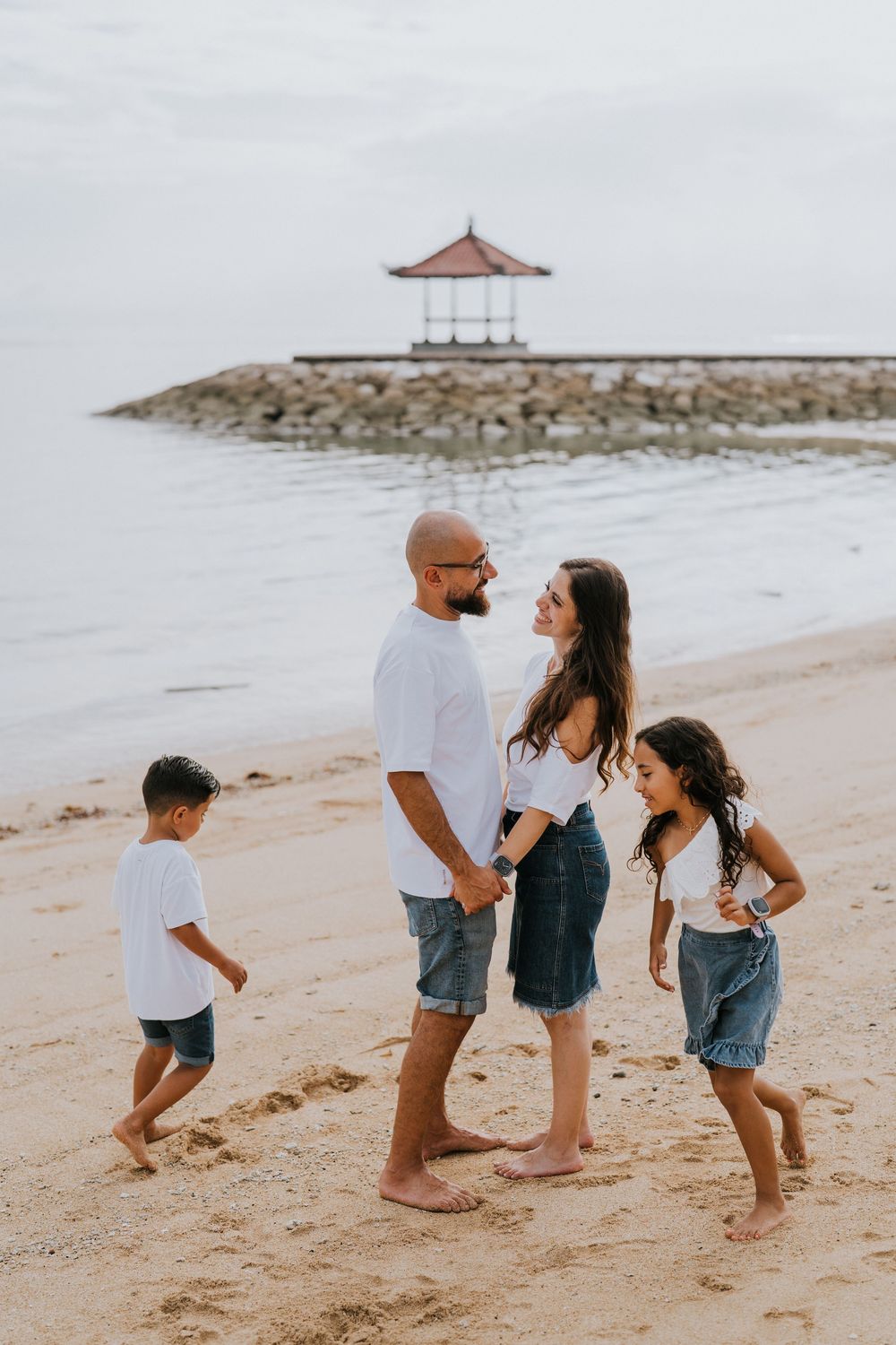 Professional family photoshoot service with beach and ocean background.