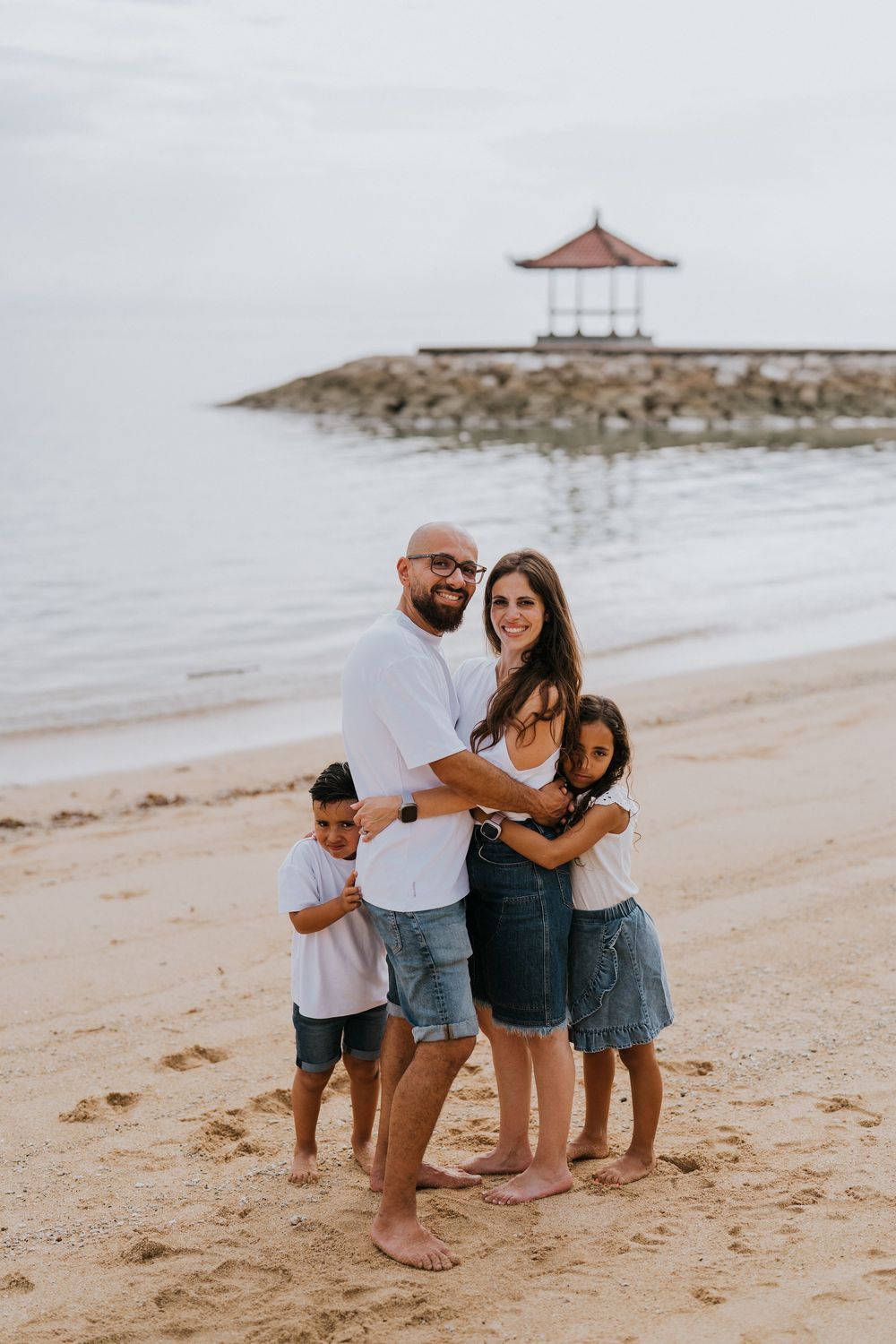 Professional family photoshoot service with beach and ocean background.