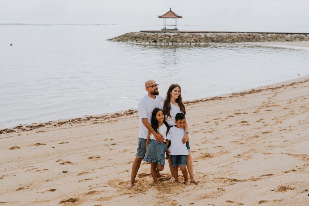 Professional family photoshoot service with beach and ocean background.