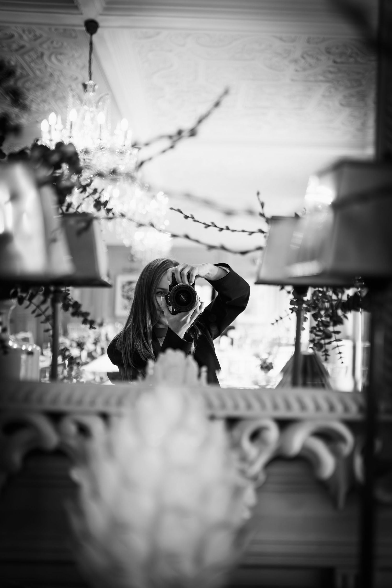 A series of black and white silhouettes show a photographer using a camera in different positions against a window backdrop.