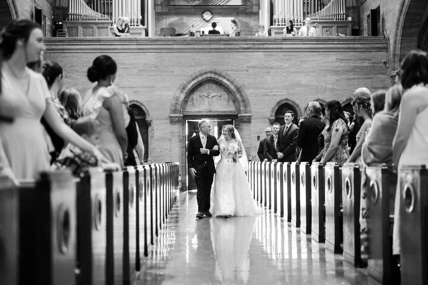 A series of black and white photos showing a wedding ceremony in a traditional church with pews and aisle views.