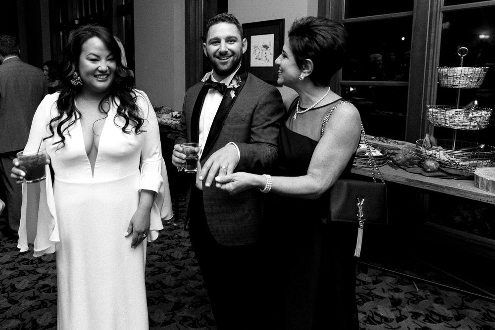 Guests enjoying themselves at an elegant evening party in formal attire.