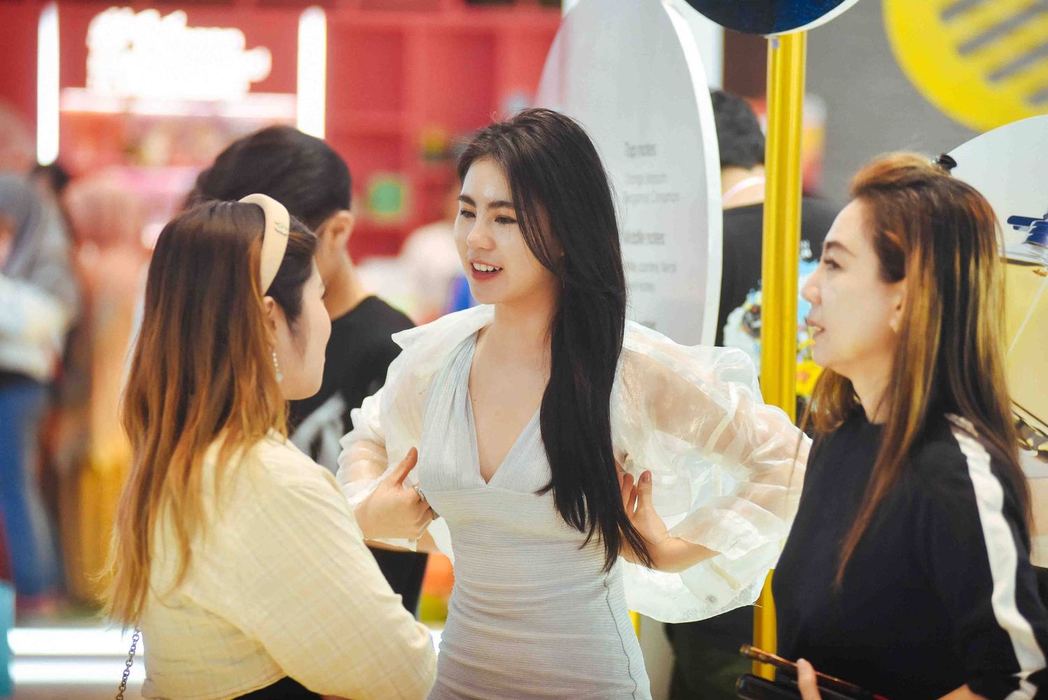 A group of people enjoying beverages and socializing at an indoor establishment.