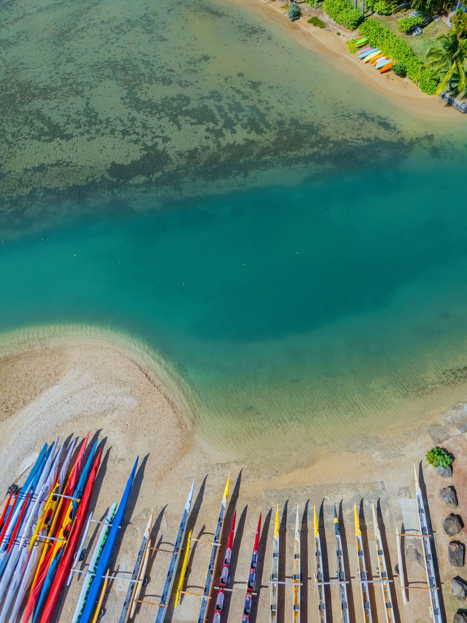aerial shot of blue water and canoes from above