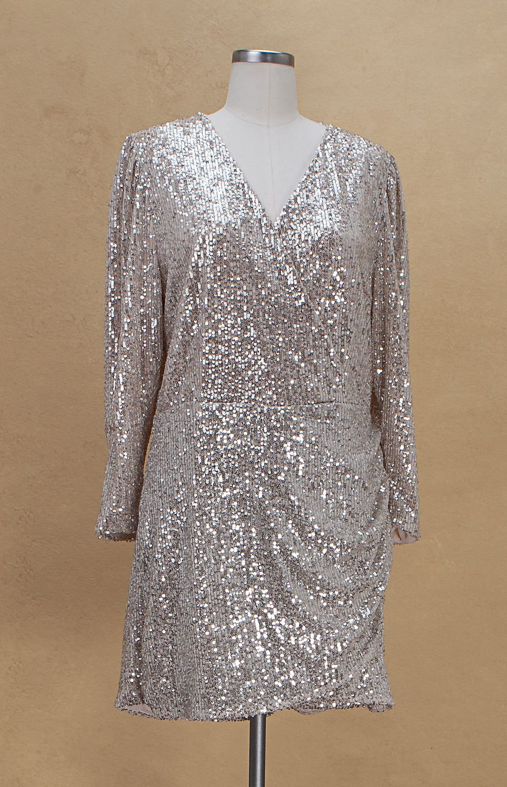 Elegant silver sequined evening top with v-neck and three-quarter length sleeves displayed on mannequin form.