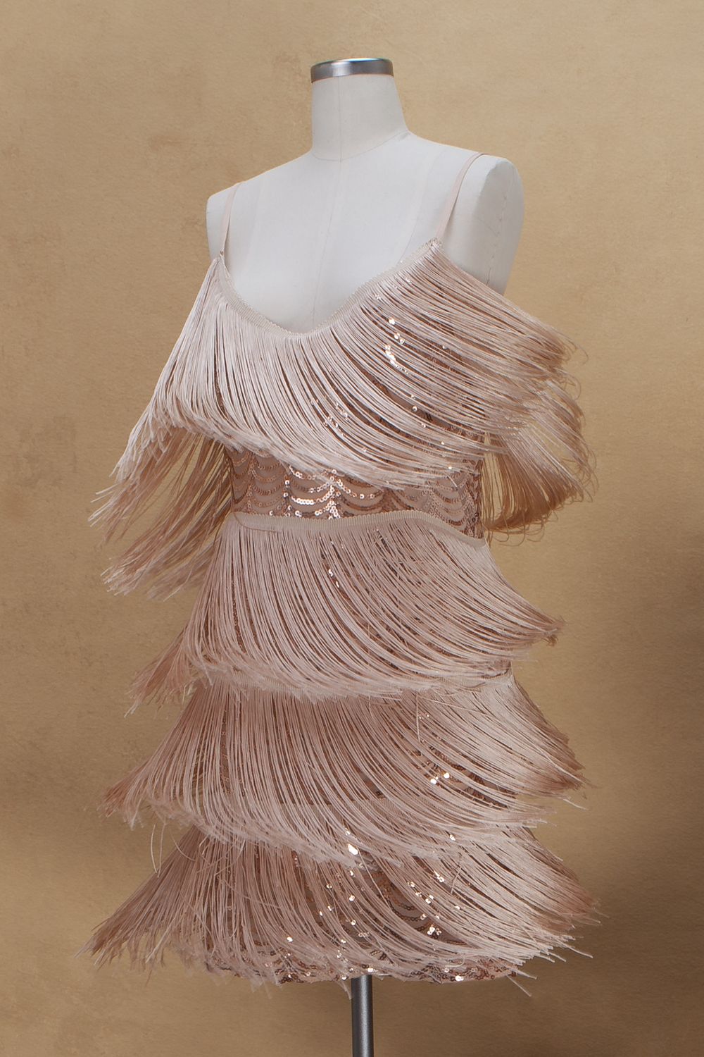 Blush pink fringe flapper dress on mannequin shown in progressive stages of construction from right to left.