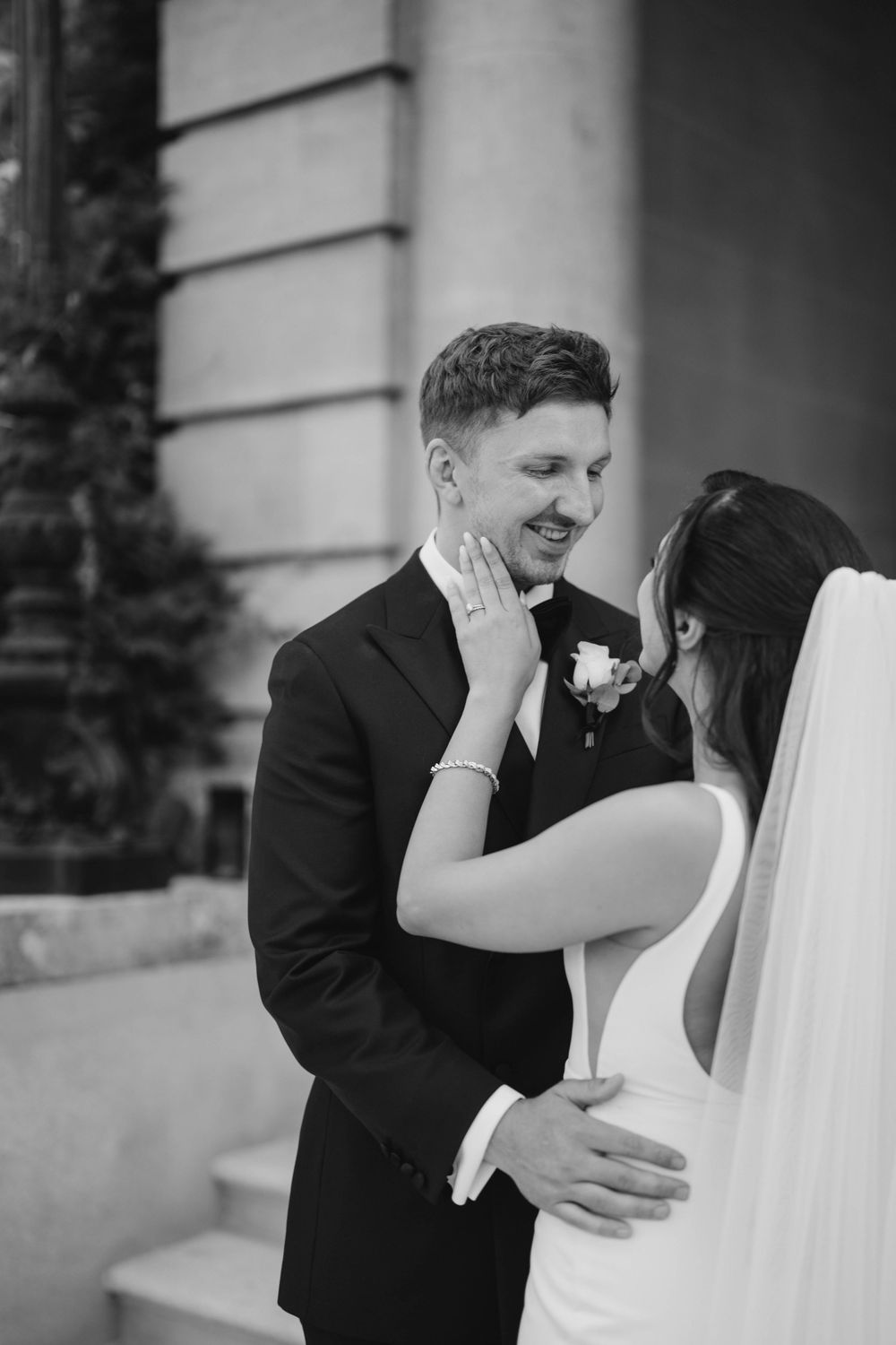 A romantic black and white photo series of a bride and groom sharing intimate moments during their wedding day.