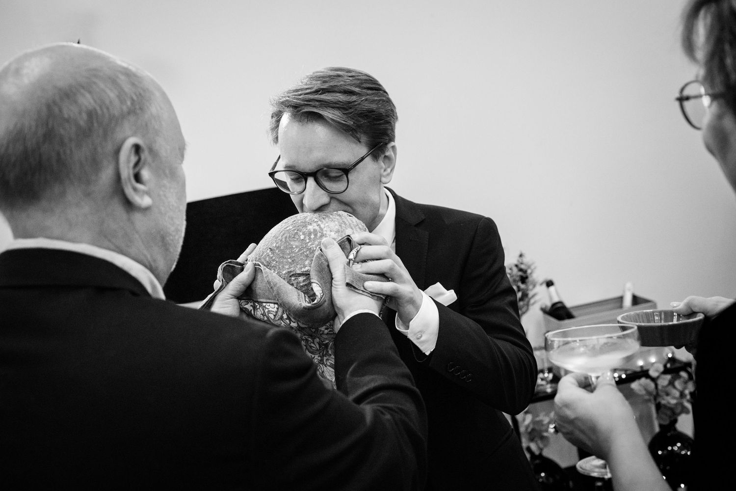 Black and white wedding photos showing emotional moments between loved ones during the ceremony and reception.