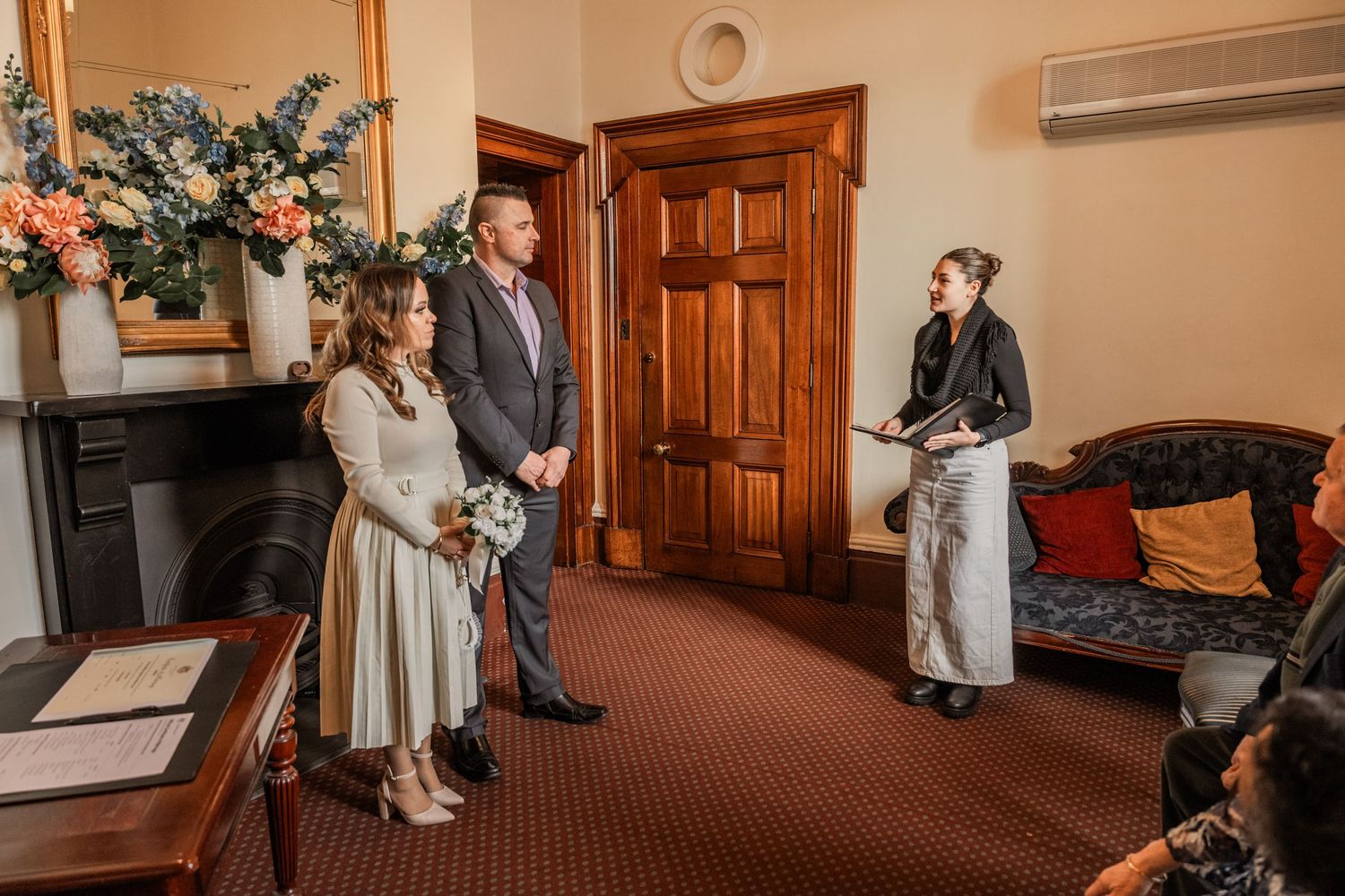A series of five photos showing wedding ceremony preparations in a church hall hallway with brown carpeting and wooden doors.