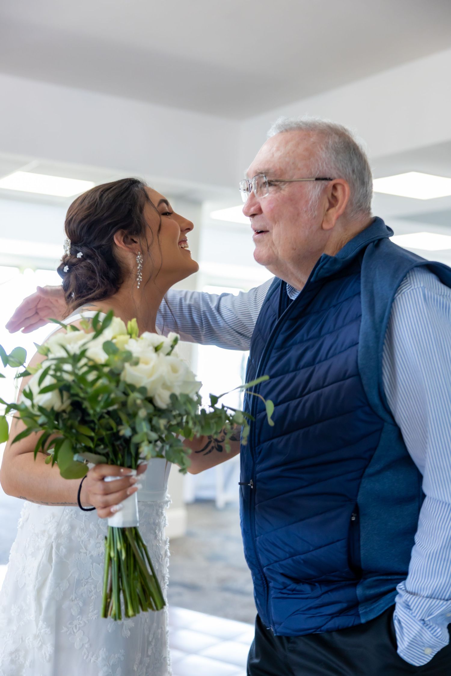 Series of candid moments showing white floral bouquets being exchanged at an indoor celebration.