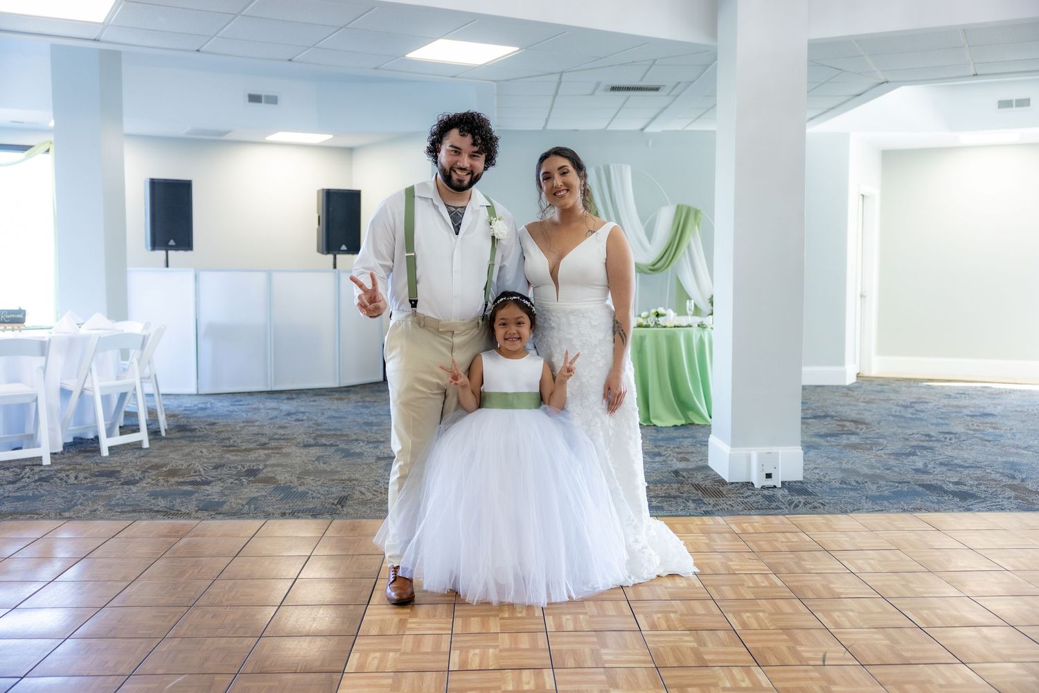 A luxury wedding venue features polished tile floors, white walls, and natural lighting from ceiling panels.