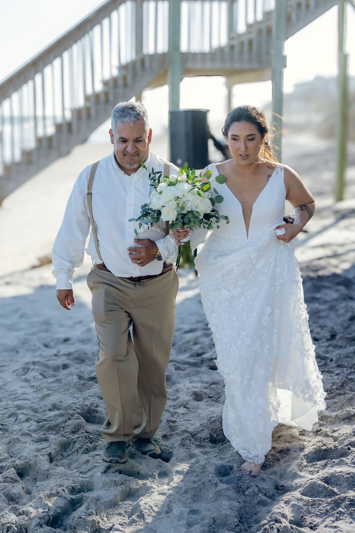 A sequence of photos showing a couple walking along sandy beach steps with flowing white fabric in the sunlight.