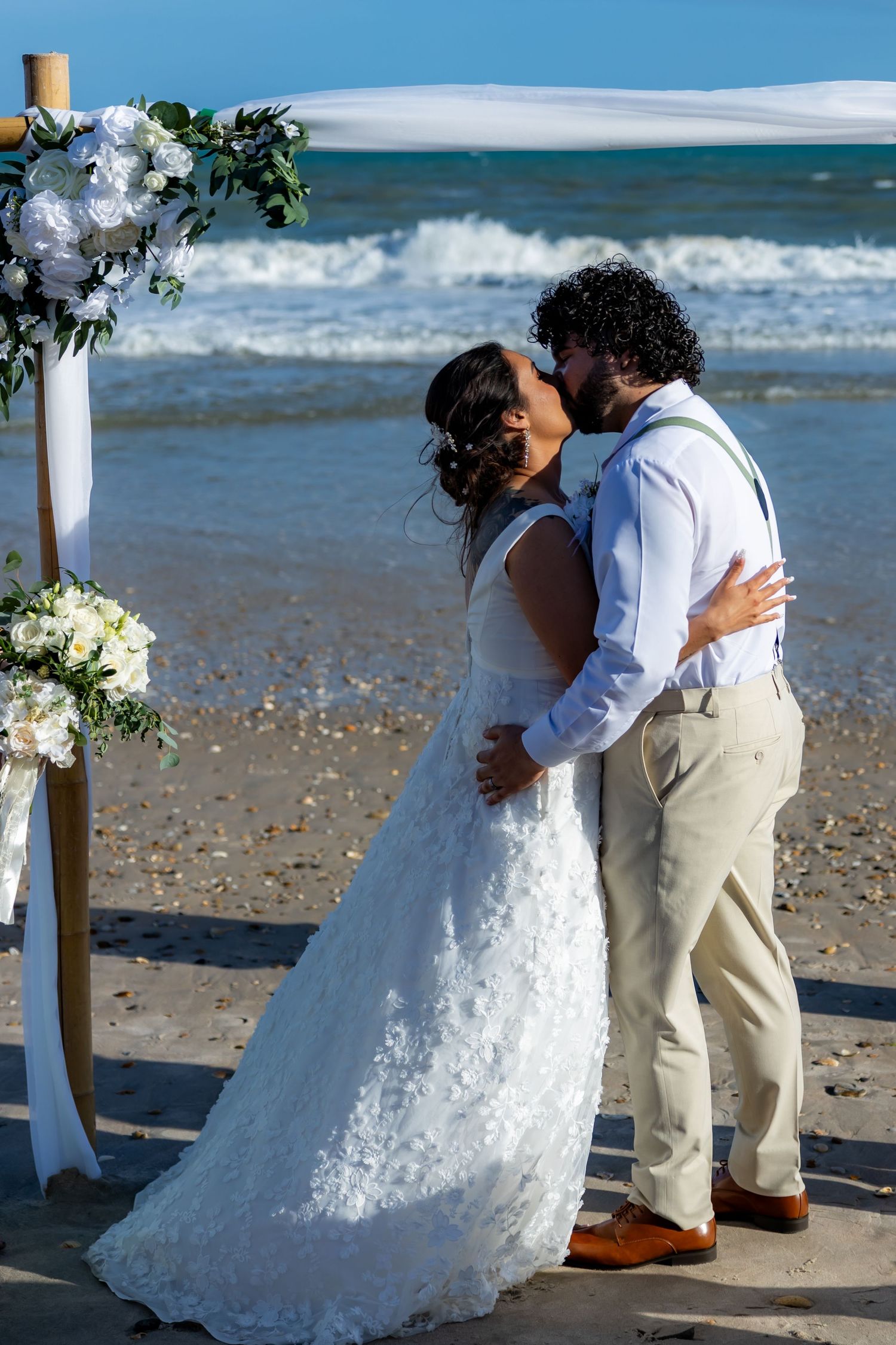 Sequence of wedding photos showing a couple sharing intimate moments on a sunny beach with ocean waves in the background.