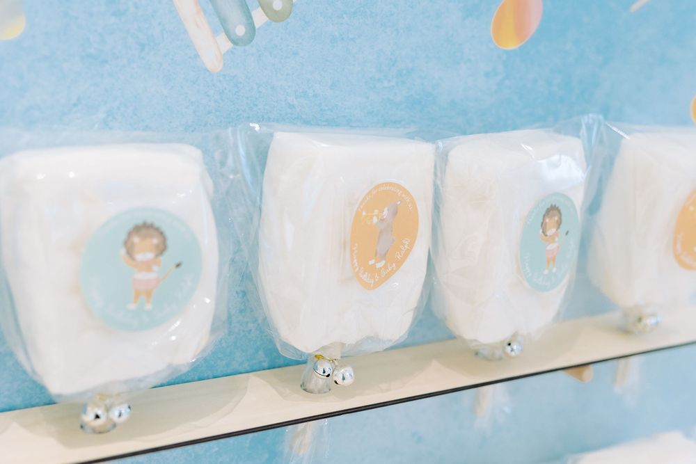 Soft plush toy characters in pastel blue and white colors arranged in a repeating pattern on fabric or paper.