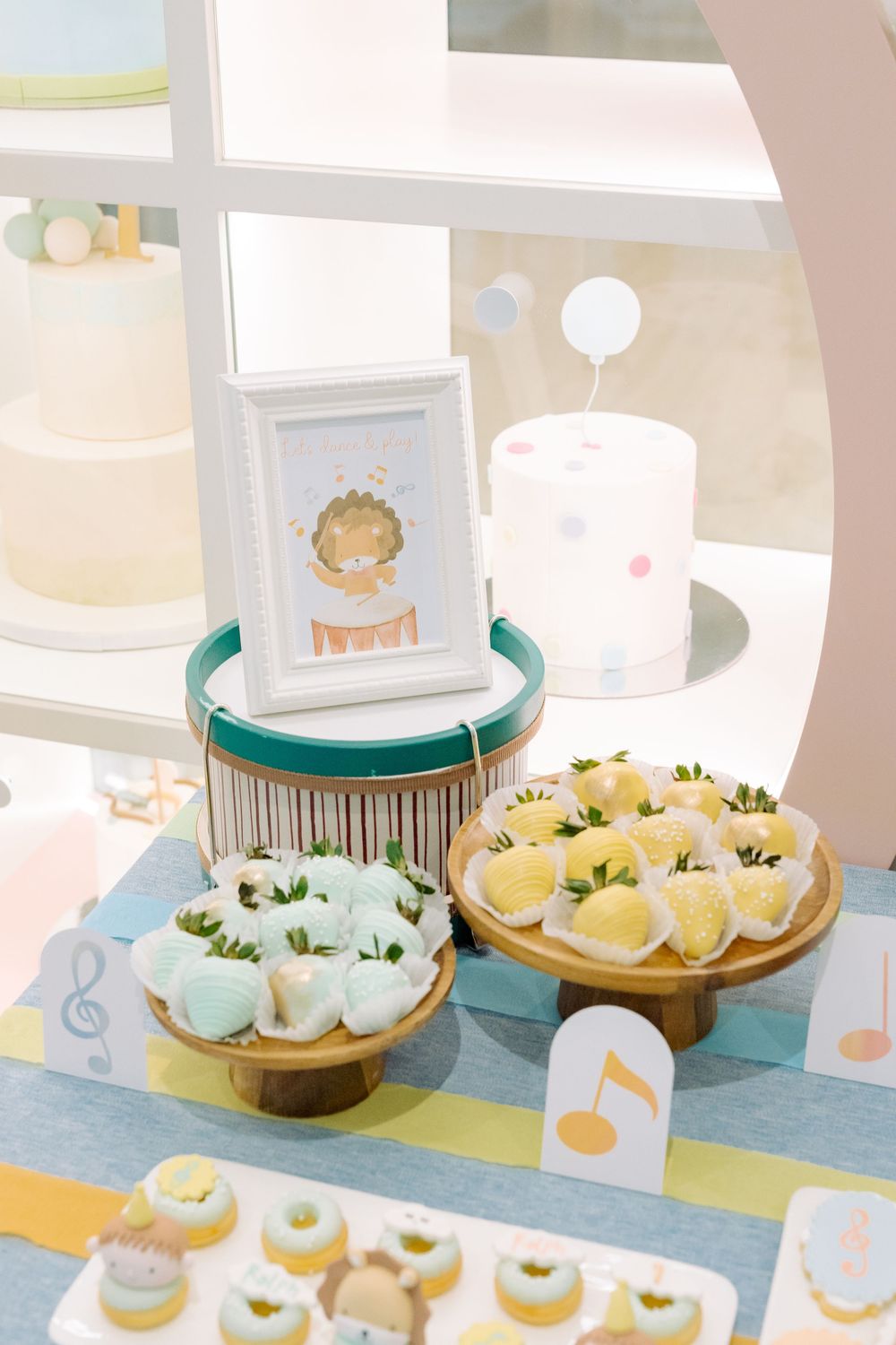 White and teal dessert table display with plated treats and decorative accents for a themed baby shower celebration.
