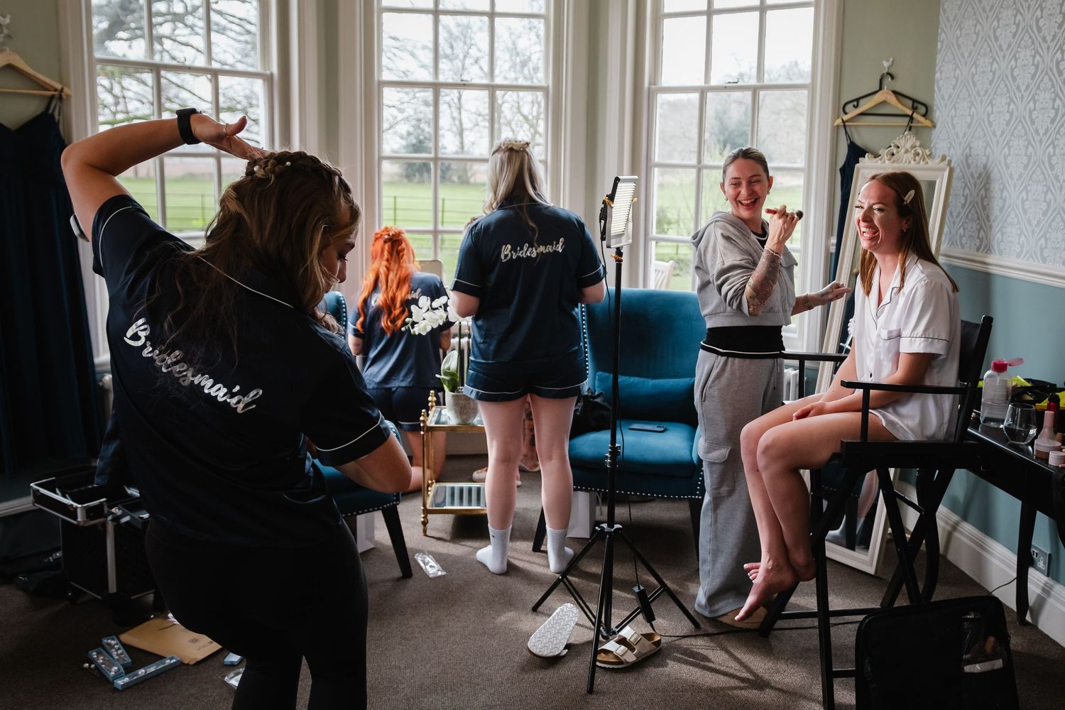 Bridesmaids and bride getting ready in the Kelham House Dressing Room during hair and makeup preparations