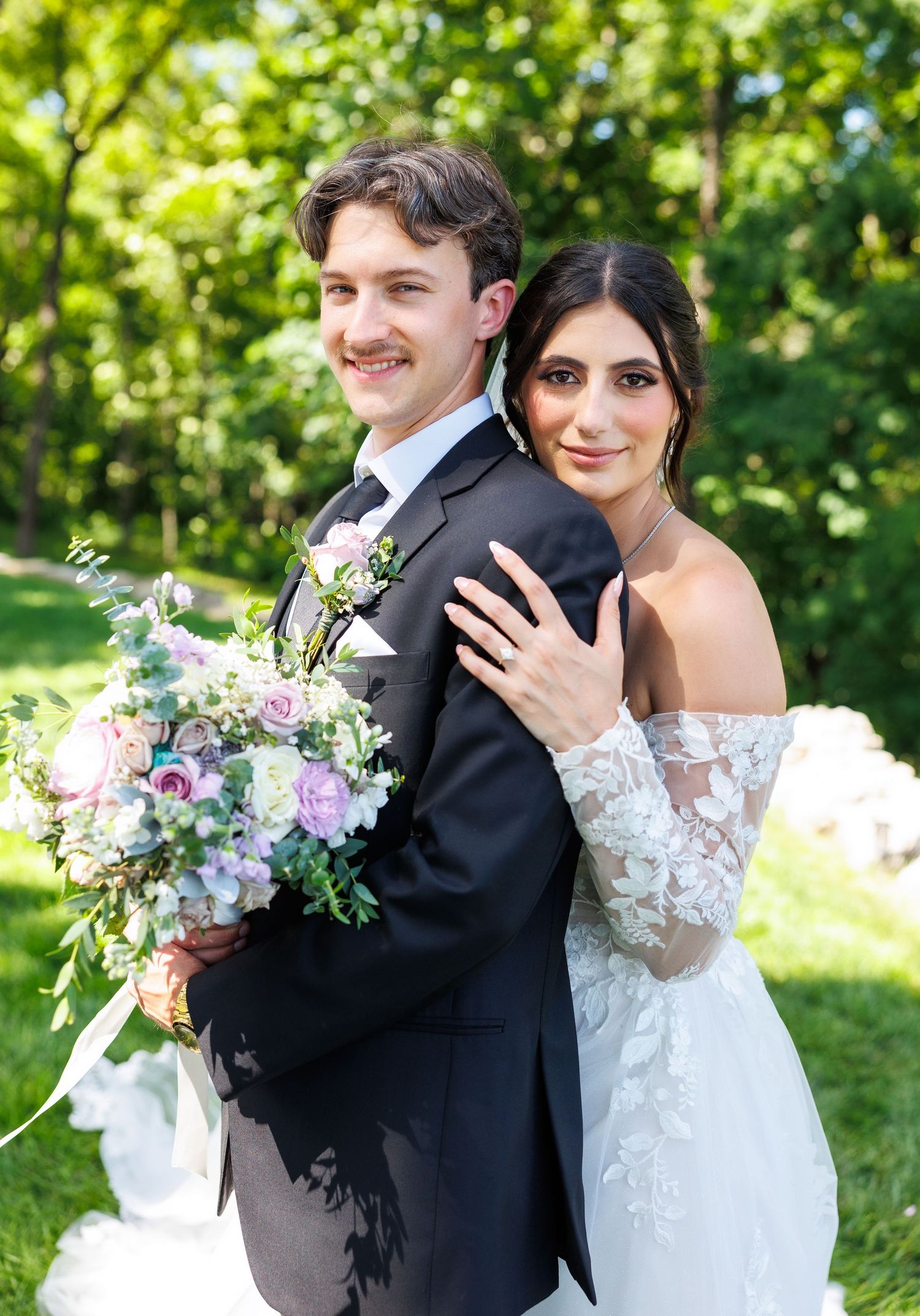 A couple twirls together outdoors under string lights at their wedding, creating a romantic sequence of candid moments at Graystone Valley.